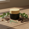 Matte black Bakhoor jar with wood lid lifestyle shot with botanicals