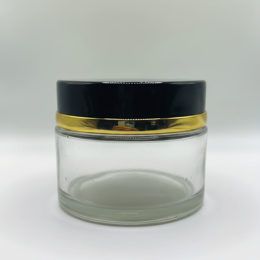 Close-up of black and gold lid detail on clear glass cosmetic jar