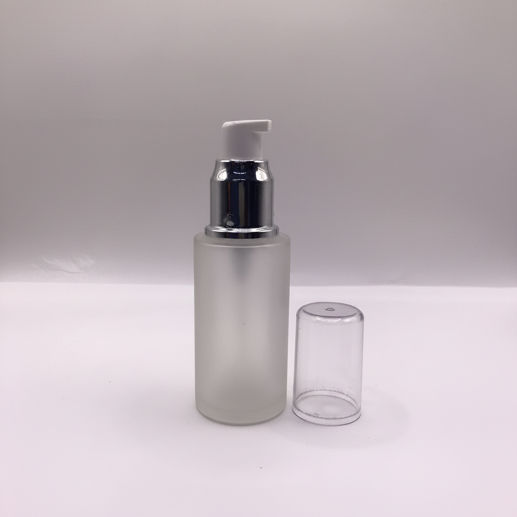 Frosted glass pump bottle studio white background